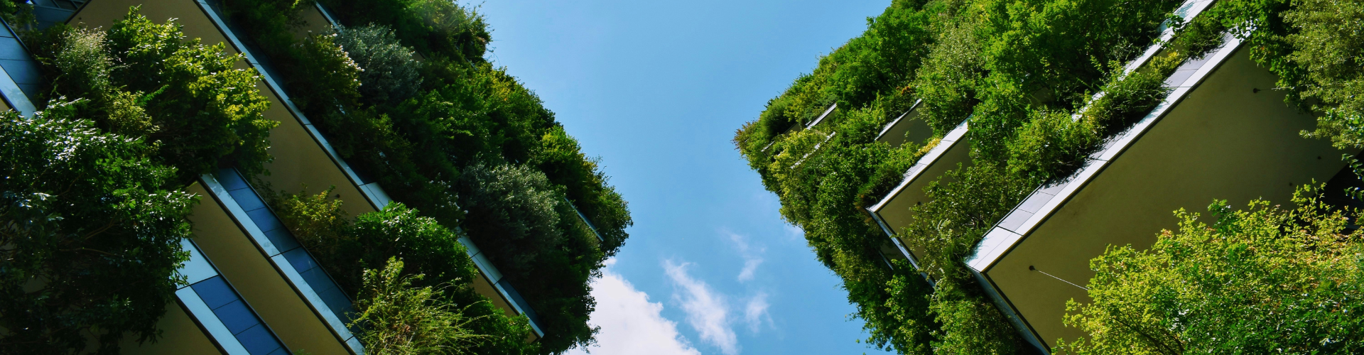 Two tall buildings with lush vertical gardens