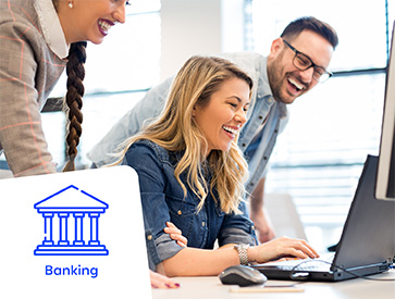 Three professionals collaborating in a workplace, with a woman using a laptop, representing the banking sector.